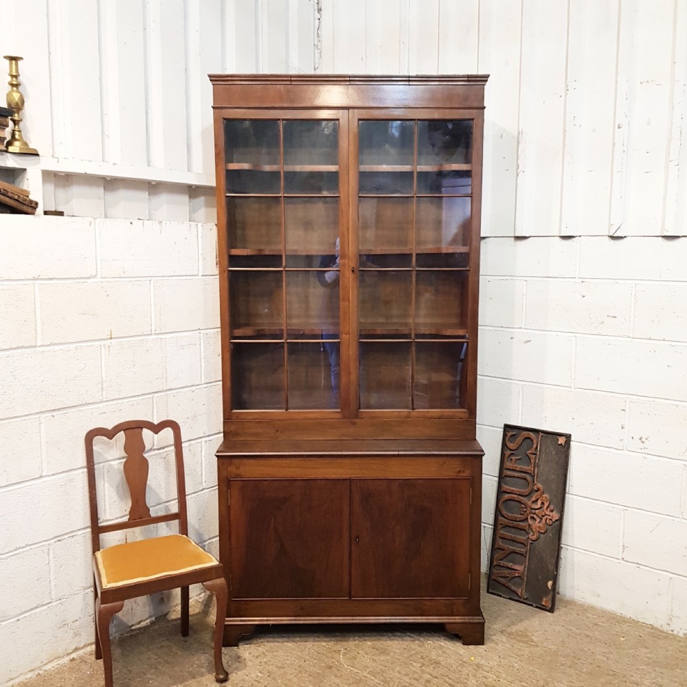 antique tall walnut glazed bookcase on cupboard c1920
