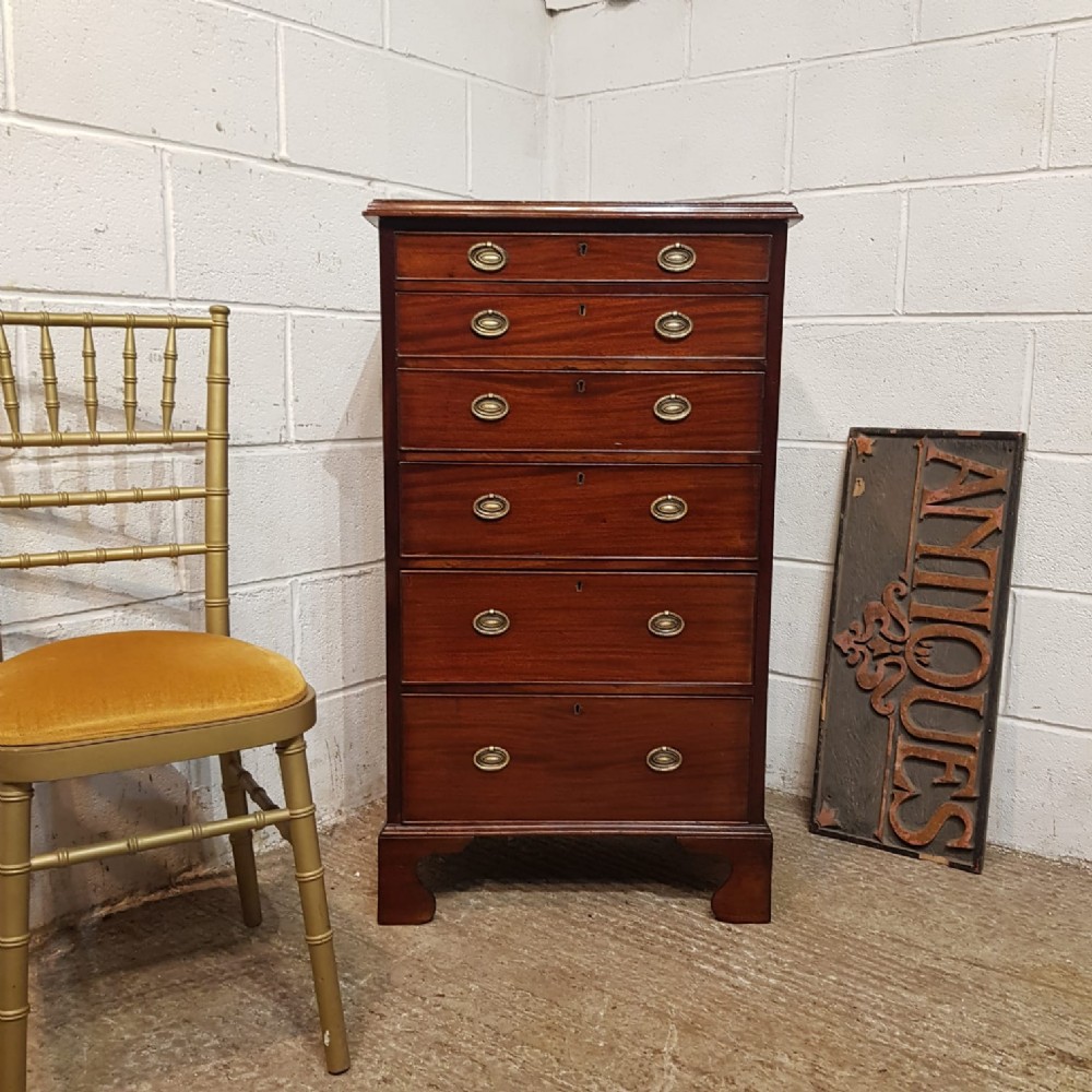 an antique tall narrow mahogany chest of drawers c1890