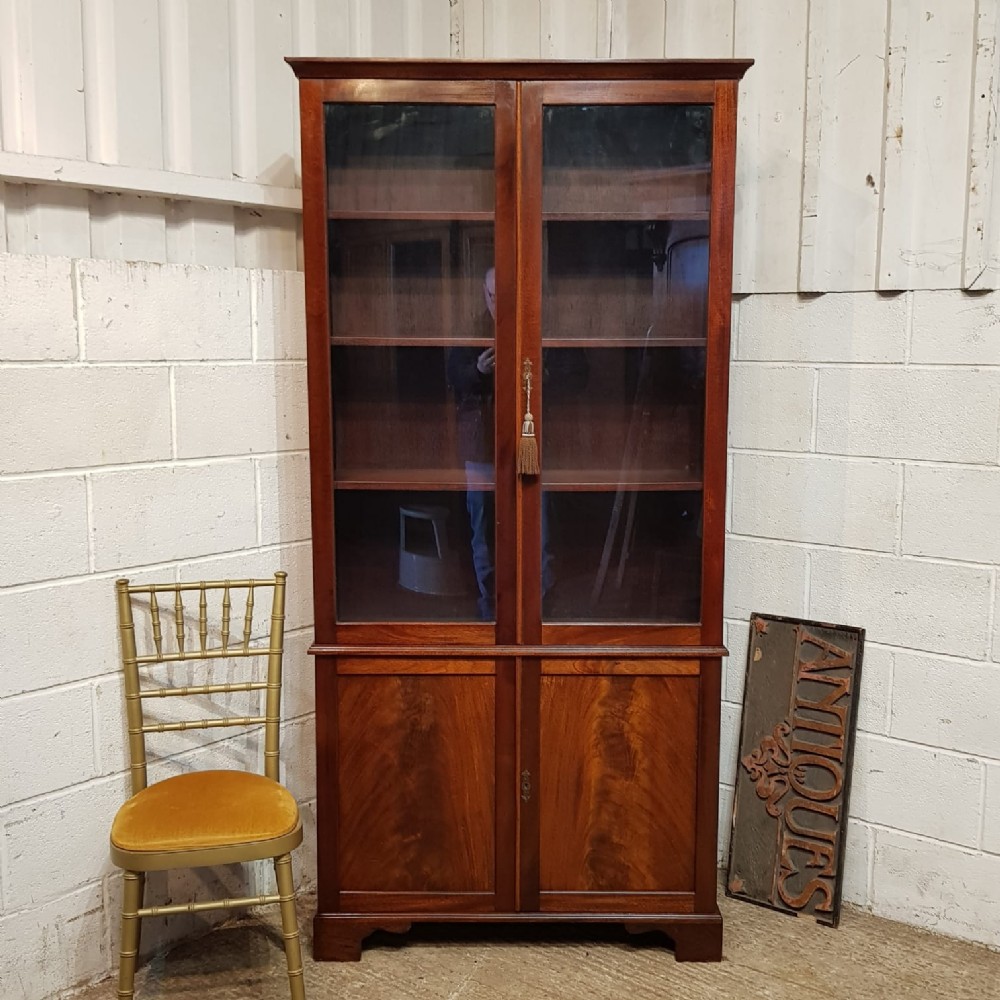 an antique tall glazed mahogany bookcase c1900