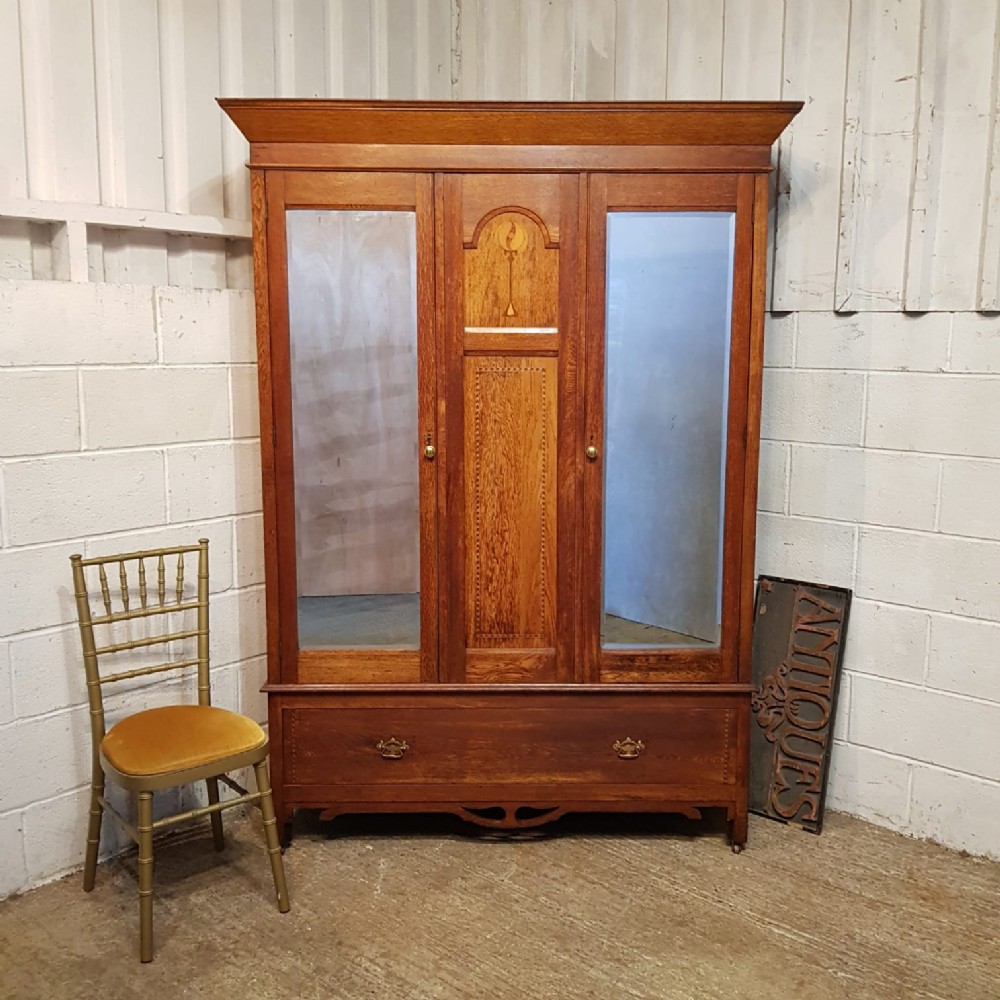 an antique oak double wardrobe c1910