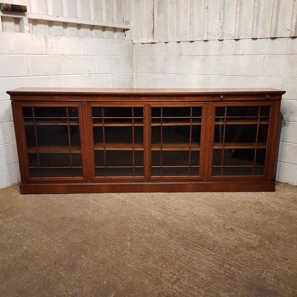 an edwardian long low glazed bookcase with book rest c1900
