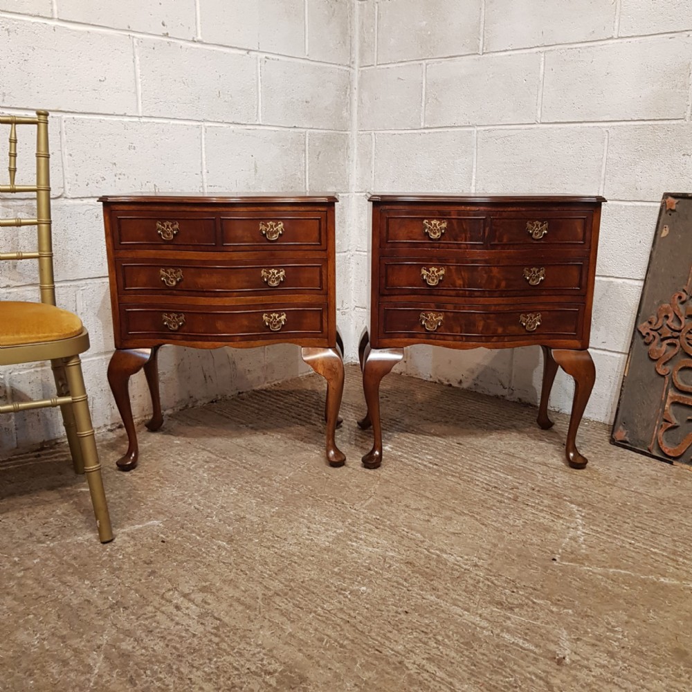 a pair of mahogany serpentine fronted bedside chests c1920