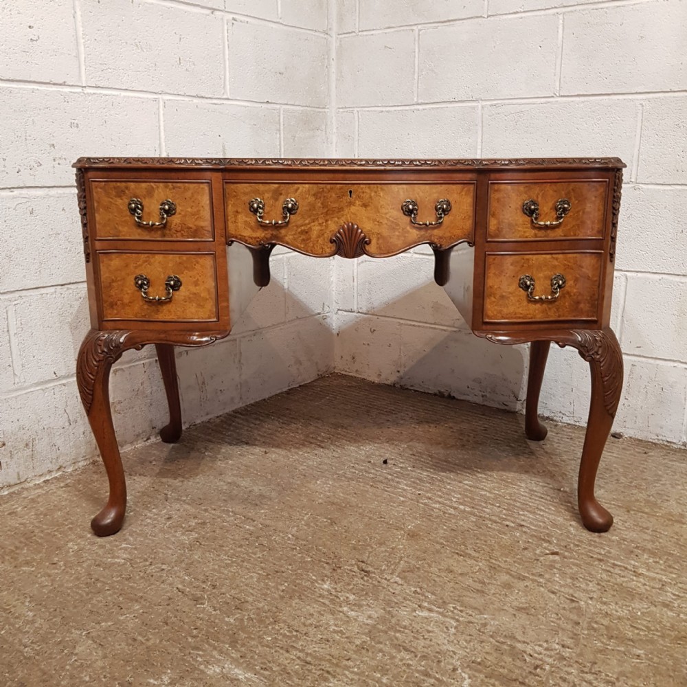 a burr walnut serpentine fronted desk c1920