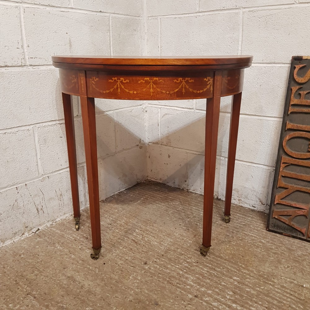 a regency mahogany inlaid demi lune fold over games side table c1810